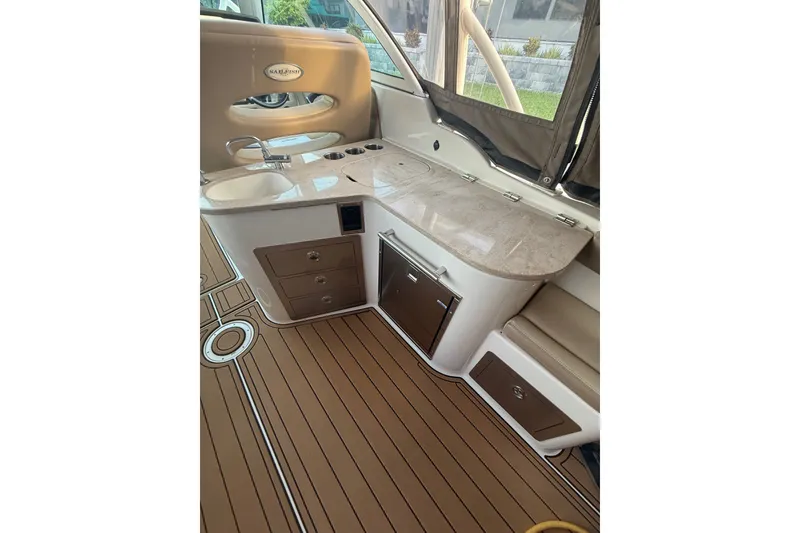 Slide: The Image of Interior of 2017 Sailfish 325 DC boat with sleek countertop and wooden flooring. - 4