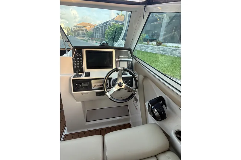 Slide: The Image of Helm of 2017 Sailfish 325 DC boat with steering wheel and control panel. - 3