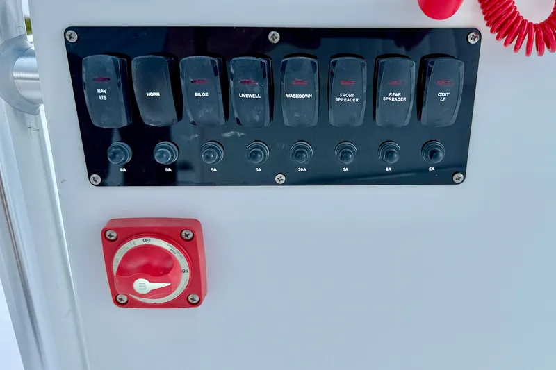 Slide: The Image of Control panel of 2027 C-Hawk 25 Center Console boat with switches and red dial. - 20