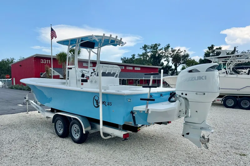 Slide: The Image of 2027 C-Hawk 25 Center Console boat with Suzuki engine on trailer, parked outdoors. - 4