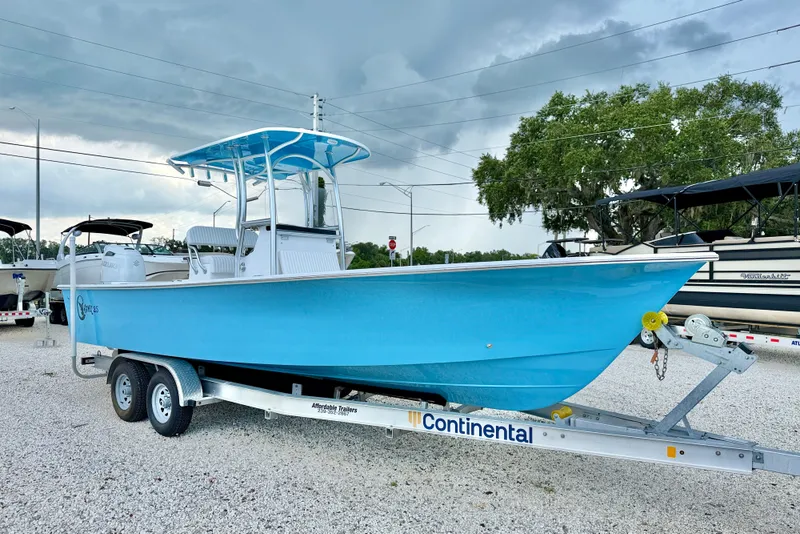 Slide: The Image of 2027 C-Hawk 25 Center Console boat on trailer, parked outdoors under cloudy sky. - 3