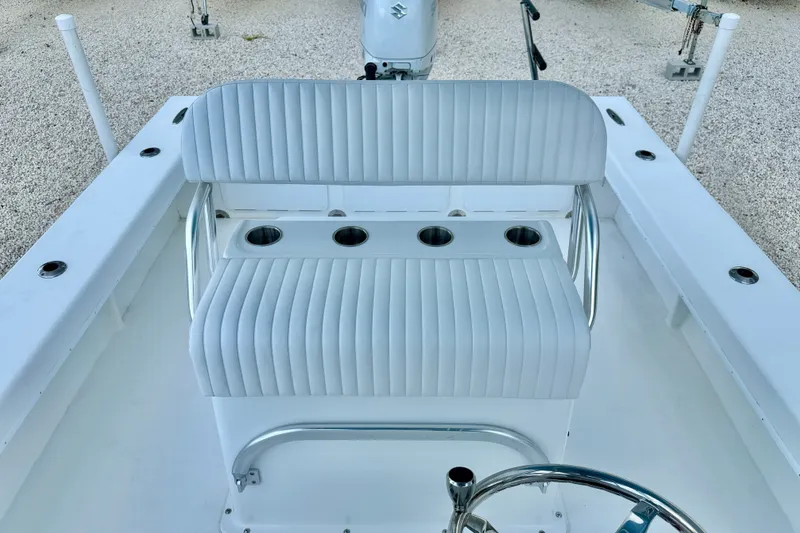 Slide: The Image of 2027 C-Hawk 25 Center Console boat interior with cushioned seating and cup holders. - 17