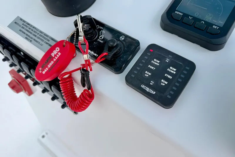 Slide: The Image of Control panel of 2027 C-Hawk 25 Center Console boat with key and switches. - 21