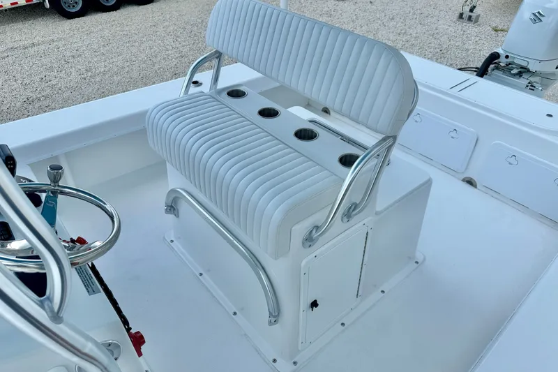 Slide: The Image of 2027 C-Hawk 25 Center Console boat interior with white seating and cup holders. - 16