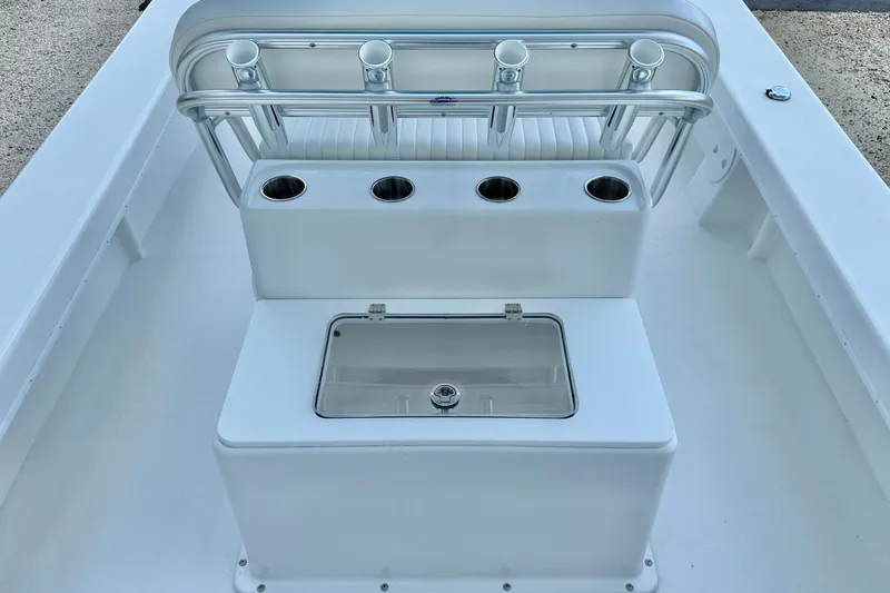 Slide: The Image of 2027 C-Hawk 25 Center Console boat interior with rod holders and storage compartment. - 25