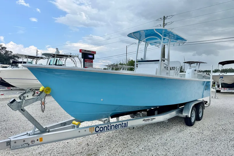 Slide: The Image of 2027 C-Hawk 25 Center Console boat on a Continental trailer, displayed outdoors. - 1