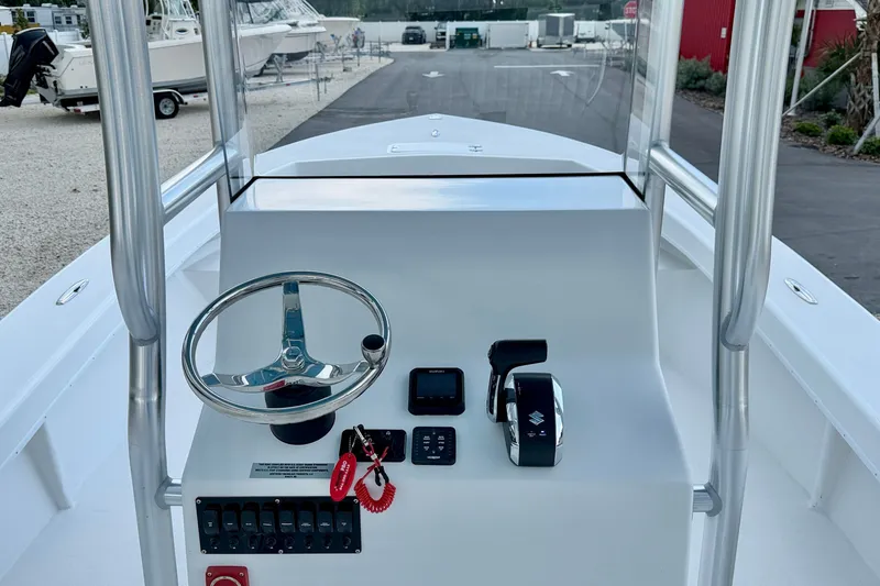 Slide: The Image of 2027 C-Hawk 25 Center Console boat dashboard with steering wheel and controls. - 18
