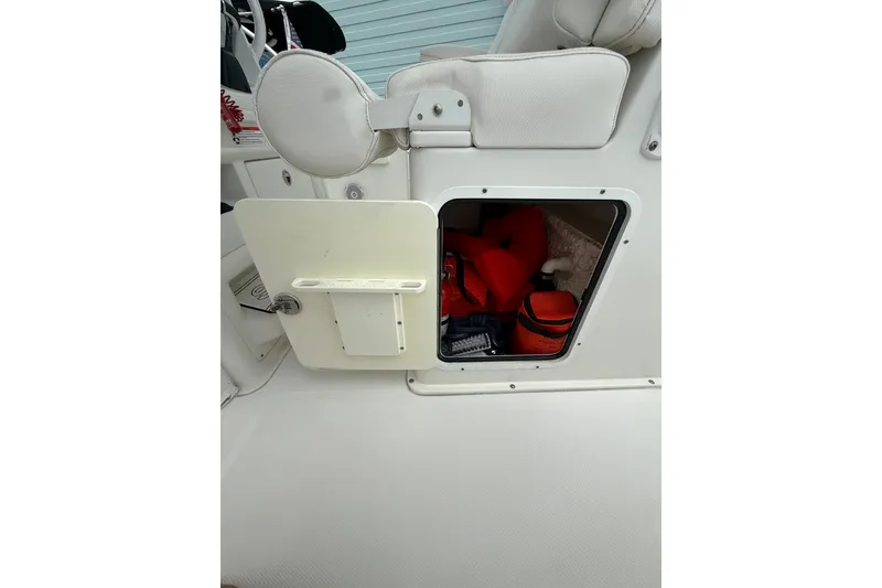 Slide: The Image of 2018 Sea Hunt Gamefish 27 storage compartment with safety gear and equipment. - 14
