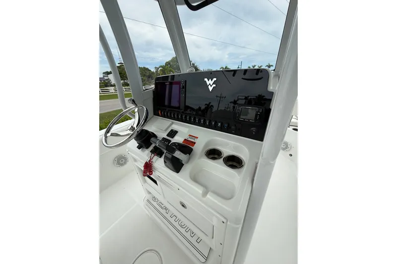 Slide: The Image of 2018 Sea Hunt Gamefish 27 boat console with steering wheel and control panel. - 5