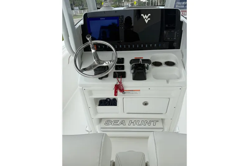 Slide: The Image of Control panel of a 2018 Sea Hunt Gamefish 27 boat with steering wheel and electronics. - 4