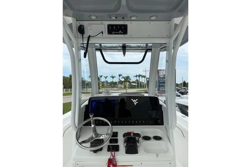 Slide: The Image of 2018 Sea Hunt Gamefish 27 boat console with steering wheel and controls. - 6