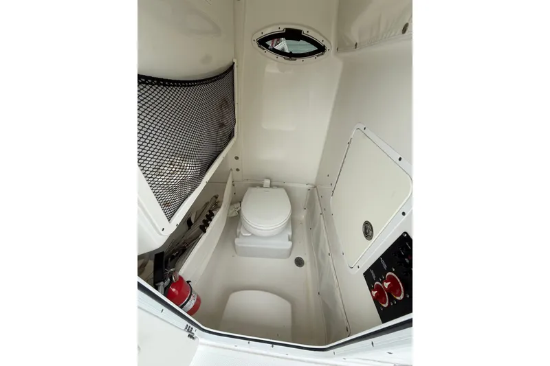 Slide: The Image of 2018 Sea Hunt Gamefish 27 boat interior with toilet and storage compartments. - 18