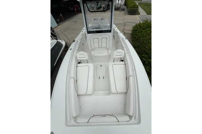Slide: The Image of 2018 Sea Hunt Gamefish 27 boat interior with white seating and spacious layout. - 7