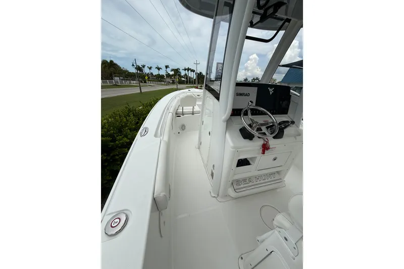 Slide: The Image of 2018 Sea Hunt Gamefish 27 boat interior with steering console and Simrad electronics. - 12