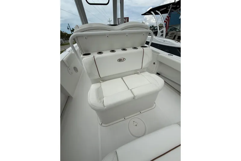Slide: The Image of 2018 Sea Hunt Gamefish 27 boat interior with white seating and cup holders. - 13