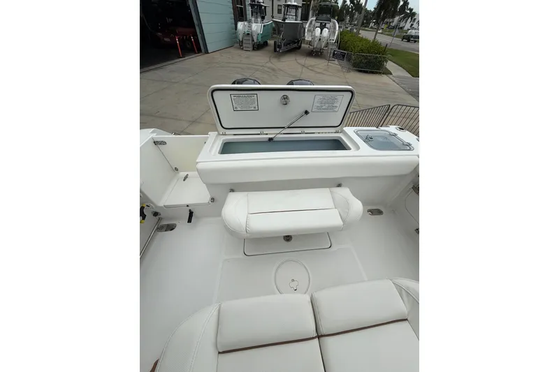 Slide: The Image of 2018 Sea Hunt Gamefish 27 boat interior with open storage compartment and seating. - 10