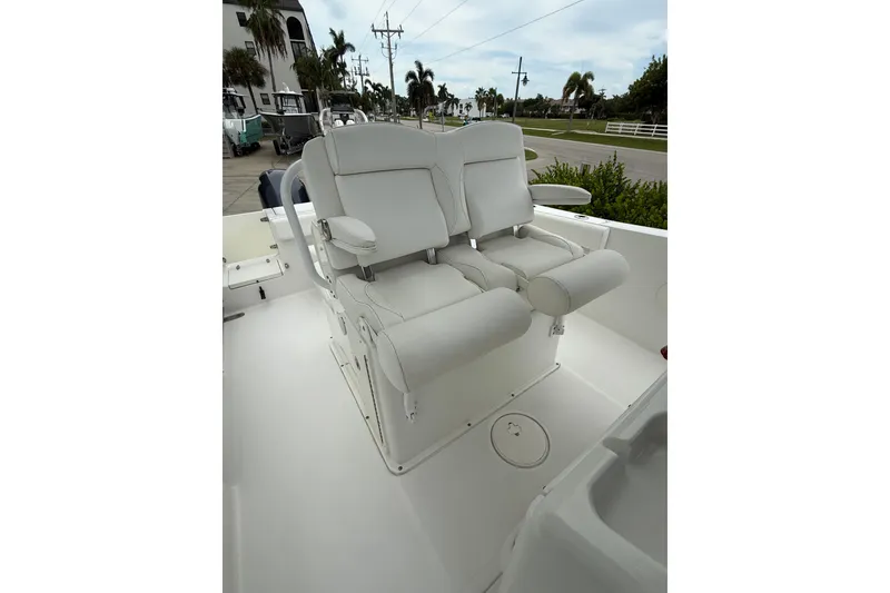 Slide: The Image of 2018 Sea Hunt Gamefish 27 boat with dual white captain's chairs on deck. - 9