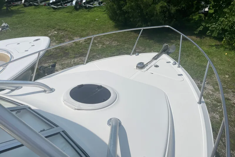 Slide: The Image of 2011 Sea Fox 256 Walk Around boat deck with railing and anchor system. - 14