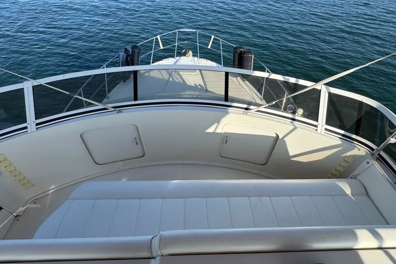 Slide: The Image of 2000 Carver 406 Aft Cabin Motor Yacht deck overlooking calm waters. - 15
