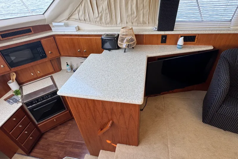 Slide: The Image of Interior of 2000 Carver 406 Aft Cabin Motor Yacht with modern kitchen amenities. - 21