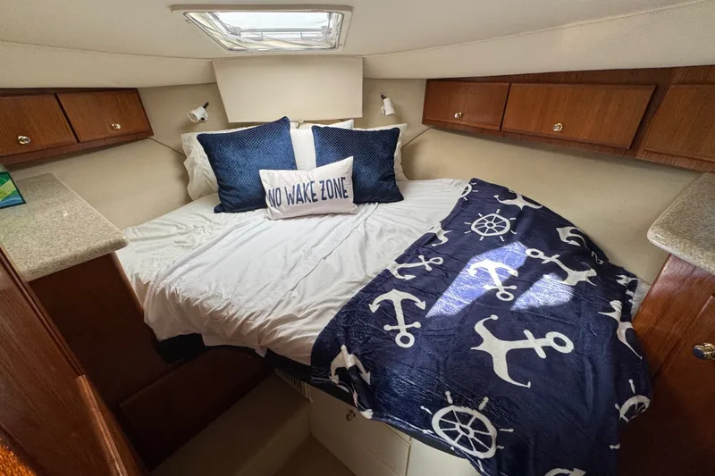 Slide: The Image of Cozy cabin bedroom in 2000 Carver 406 Aft Cabin Motor Yacht with nautical decor. - 27