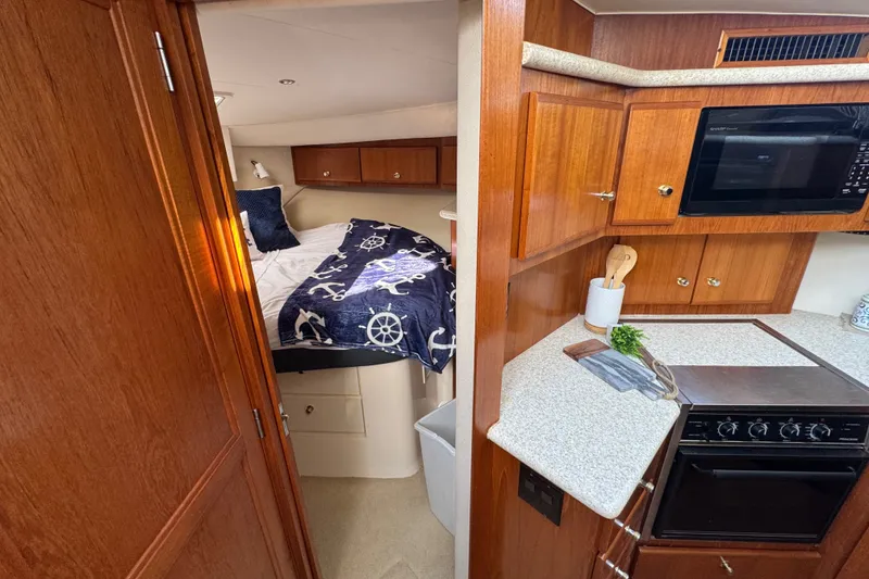 Slide: The Image of Interior of 2000 Carver 406 Aft Cabin Motor Yacht with cozy bedroom and kitchen area. - 26