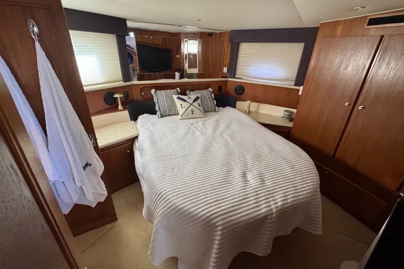 Slide: The Image of Luxurious bedroom in 2000 Carver 406 Aft Cabin Motor Yacht with cozy bedding and elegant decor. - 30