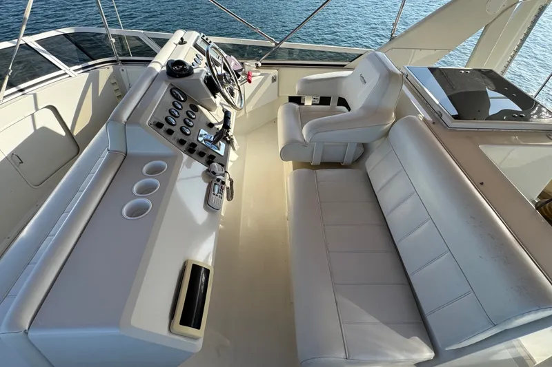Slide: The Image of Cockpit view of 2000 Carver 406 Aft Cabin Motor Yacht with white seating and control panel. - 14
