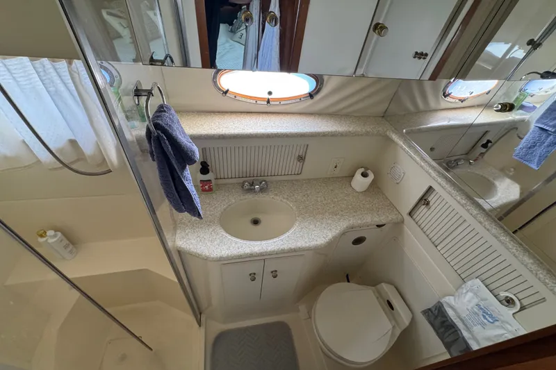 Slide: The Image of Bathroom interior of 2000 Carver 406 Aft Cabin Motor Yacht, featuring sink and toilet. - 32