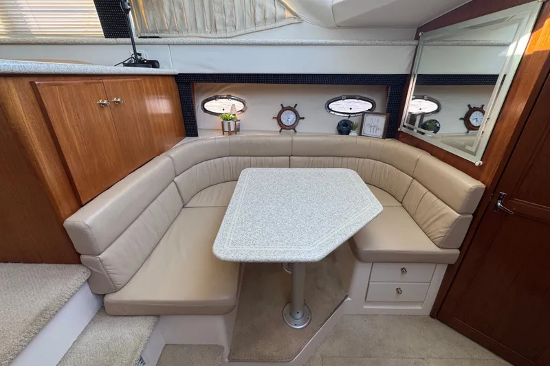 Slide: The Image of Luxurious dining area in 2000 Carver 406 Aft Cabin Motor Yacht with plush seating. - 25