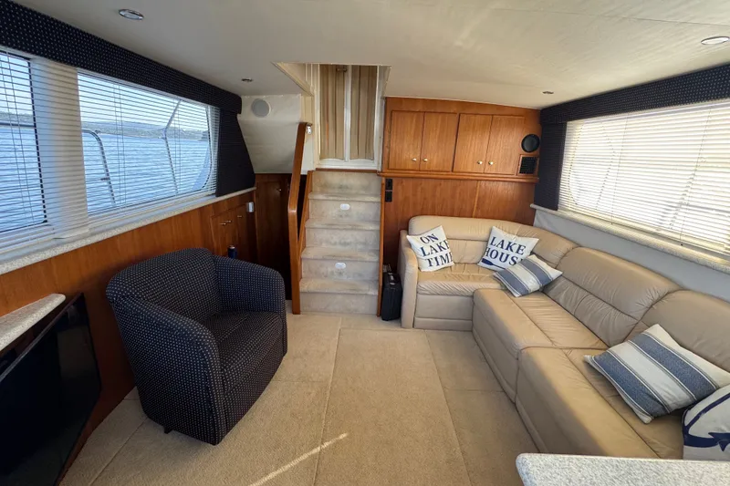 Slide: The Image of Interior of 2000 Carver 406 Aft Cabin Motor Yacht with cozy seating and nautical decor. - 18