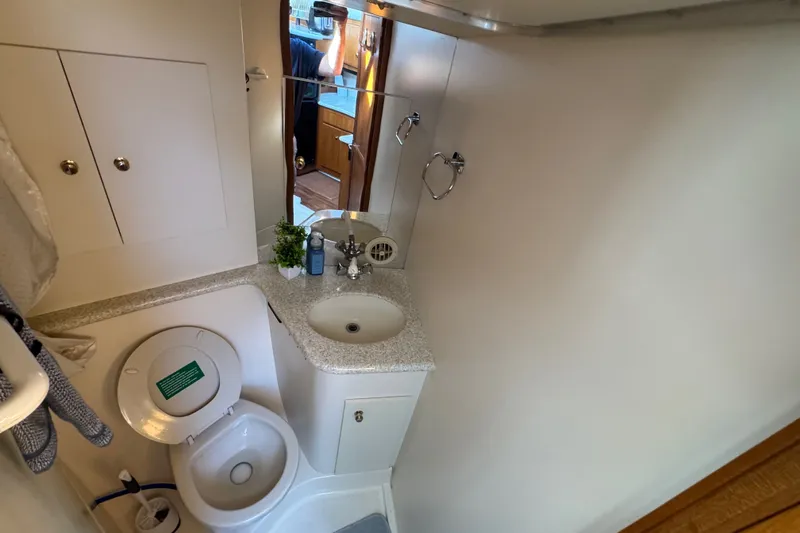 Slide: The Image of Bathroom interior of 2000 Carver 406 Aft Cabin Motor Yacht with sink and toilet. - 28
