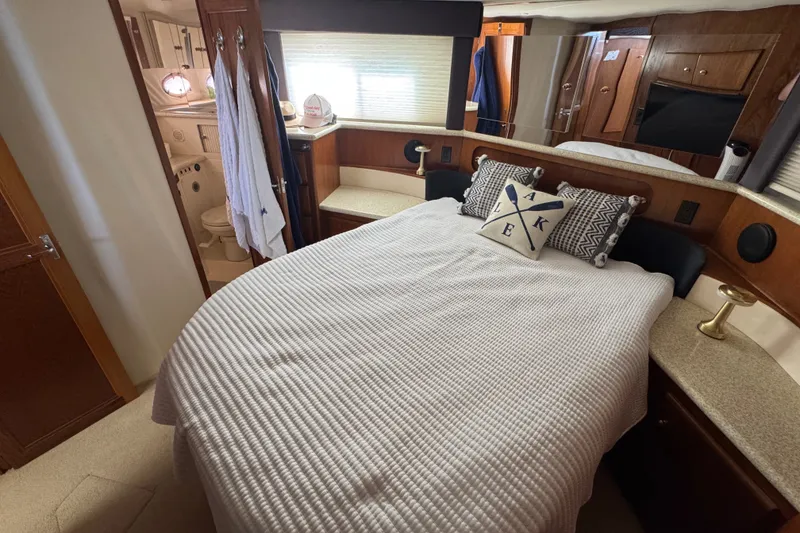 Slide: The Image of Interior of 2000 Carver 406 Aft Cabin Motor Yacht with cozy bedroom and nautical decor. - 31