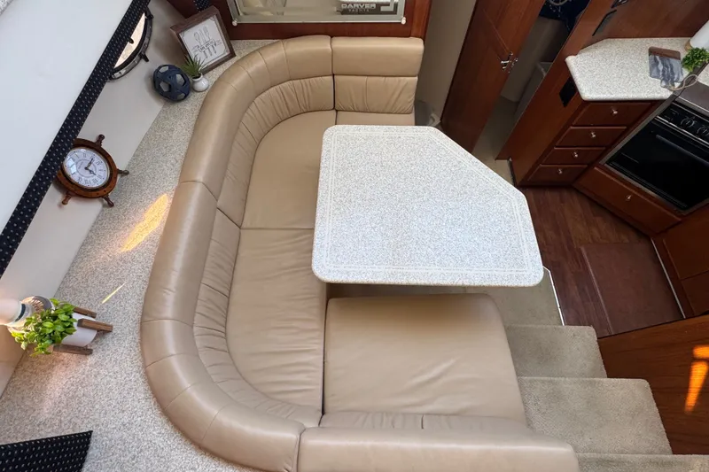 Slide: The Image of Interior of 2000 Carver 406 Aft Cabin Motor Yacht with beige seating and table. - 23