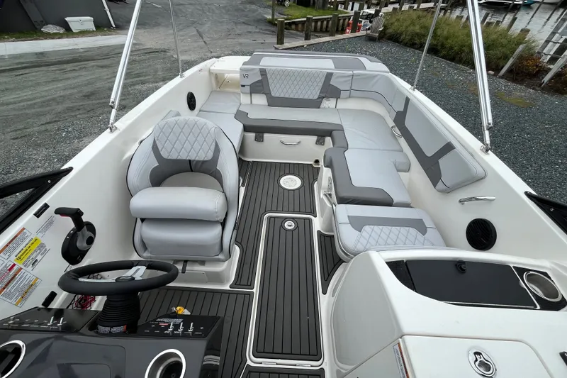 Slide: The Image of 2023 Bayliner VR6 Bowrider I/O interior with gray seating and modern dashboard. - 5