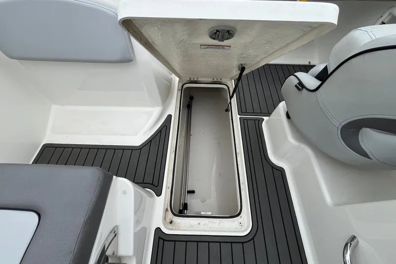 Slide: The Image of 2023 Bayliner VR6 Bowrider I/O interior storage compartment with open hatch. - 10