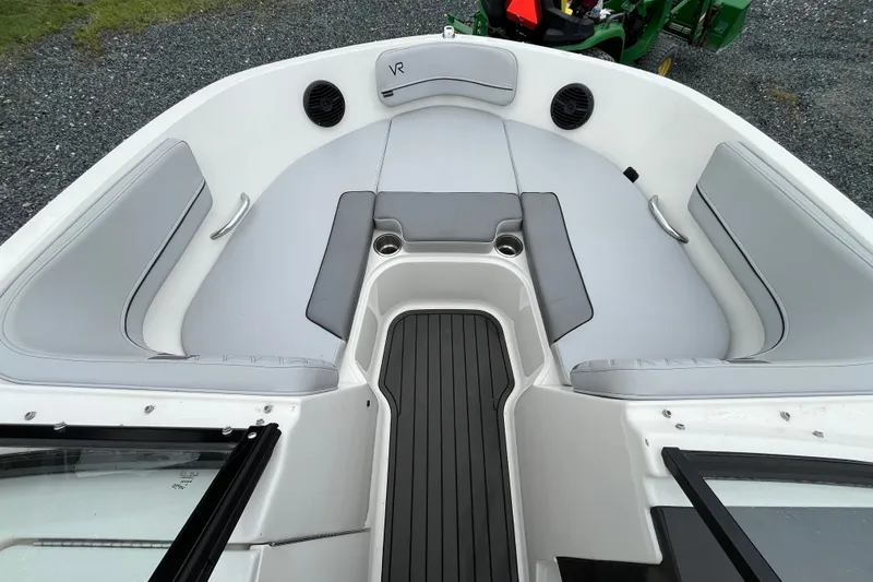 Slide: The Image of 2023 Bayliner VR6 Bowrider I/O interior with gray seating and cup holders. - 12
