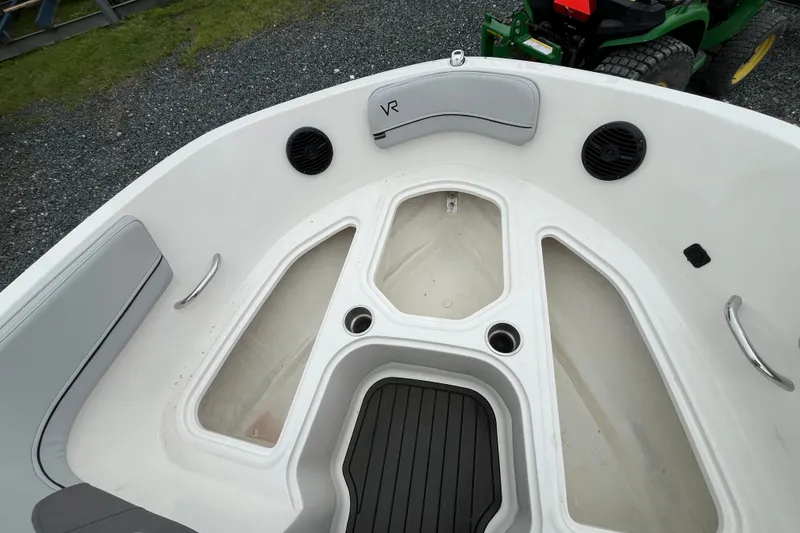 Slide: The Image of 2023 Bayliner VR6 Bowrider I/O boat interior with seating and storage compartments. - 13