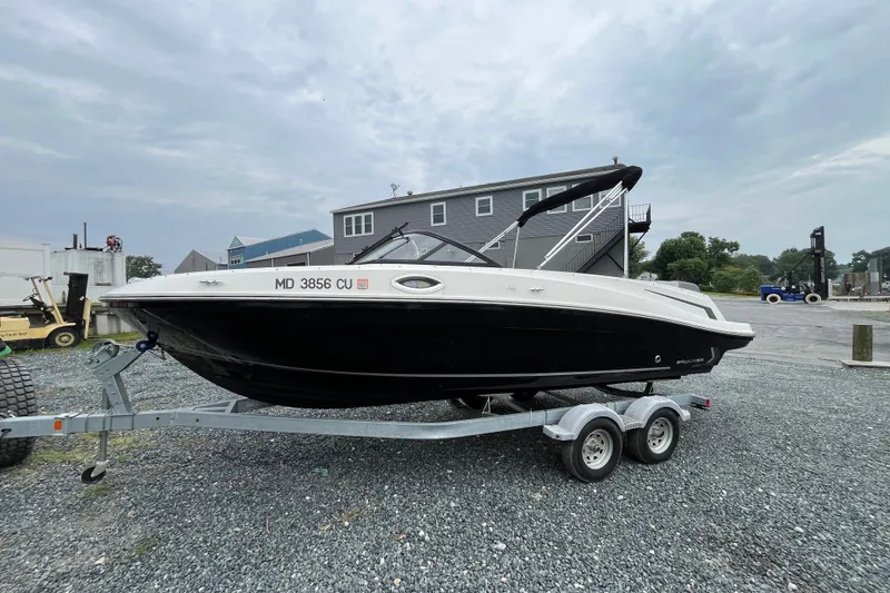 Slide: The Image of 2023 Bayliner VR6 Bowrider I/O on trailer, parked outdoors on gravel. - 3