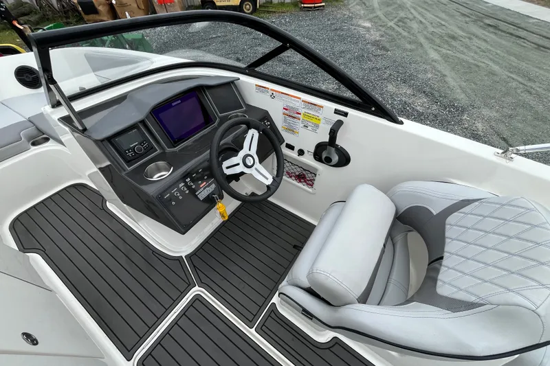 Slide: The Image of 2023 Bayliner VR6 Bowrider I/O cockpit with modern dashboard and comfortable seating. - 9