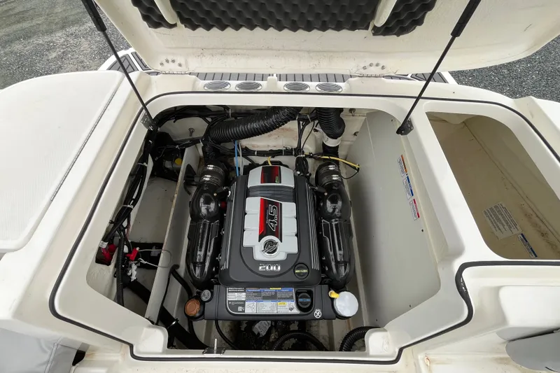 Slide: The Image of 2023 Bayliner VR6 Bowrider I/O engine compartment with open hatch, showcasing the engine. - 7