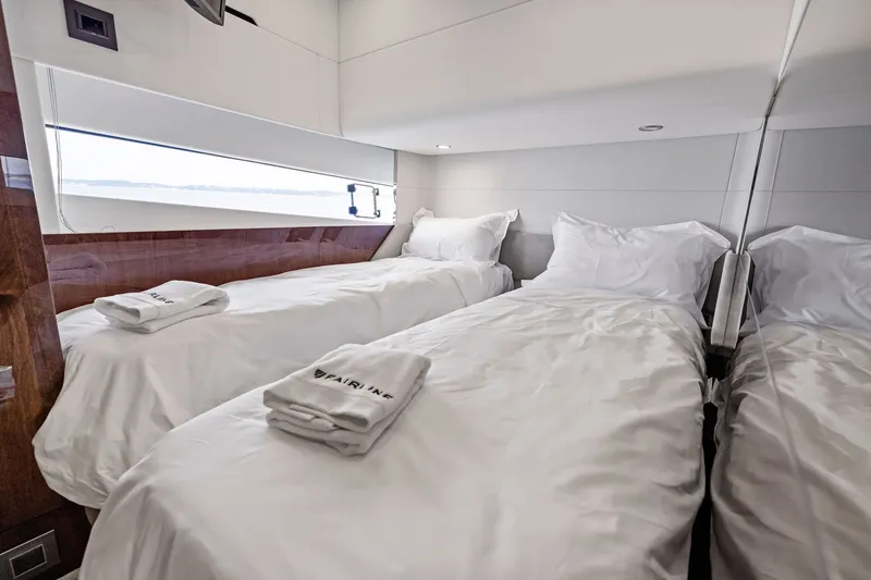 Slide: The Image of Luxurious twin cabin interior of 2024 Fairline Phantom 65 yacht with elegant bedding. - 48