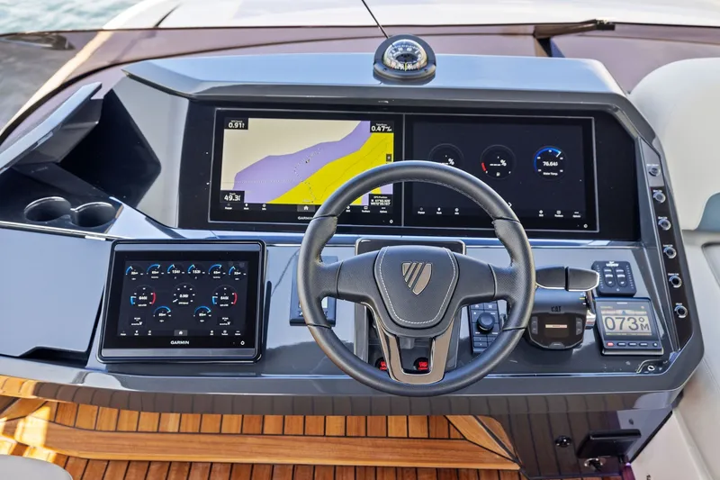 Slide: The Image of 2024 Fairline Phantom 65 helm with advanced navigation displays and controls. - 57