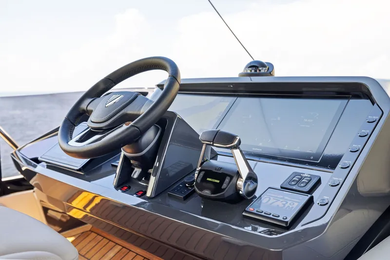 Slide: The Image of Helm of 2024 Fairline Phantom 65 yacht with modern controls and navigation display. - 58