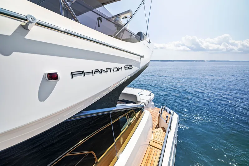 Slide: The Image of 2024 Fairline Phantom 65 yacht on serene ocean waters, showcasing sleek design and luxury. - 66