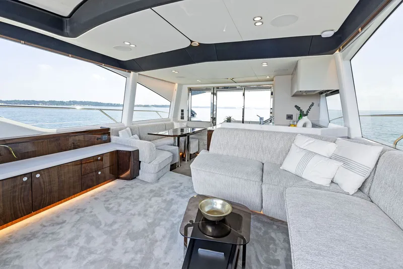 Slide: The Image of Luxurious interior of 2024 Fairline Phantom 65 yacht with elegant seating and panoramic windows. - 19