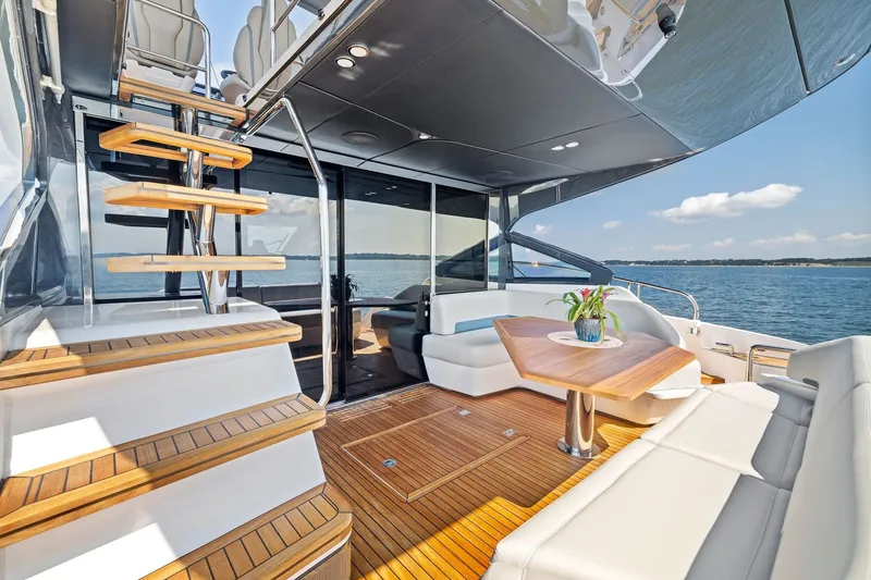 Slide: The Image of Luxurious 2024 Fairline Phantom 65 yacht interior with elegant seating and ocean view. - 11