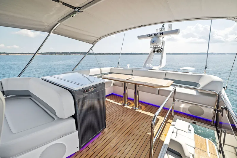 Slide: The Image of Luxurious 2024 Fairline Phantom 65 yacht deck with seating and ocean view. - 61