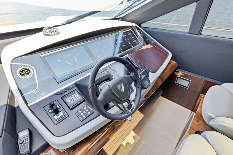 Slide: The Image of 2024 Fairline Phantom 65 yacht helm with modern controls and sleek design. - 22