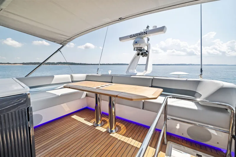 Slide: The Image of Luxurious 2024 Fairline Phantom 65 yacht deck with elegant seating and wooden table. - 56
